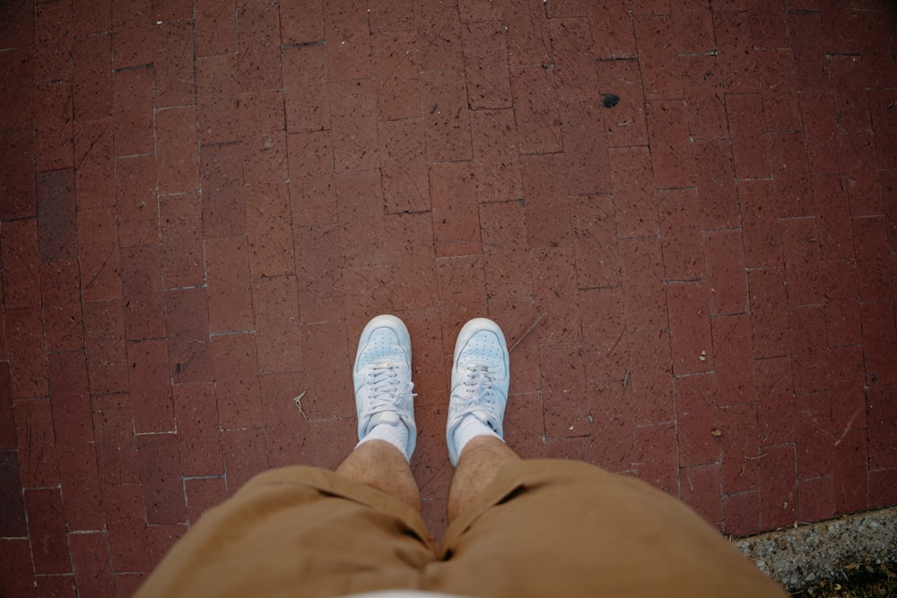 a person's feet with white tennis shoes on