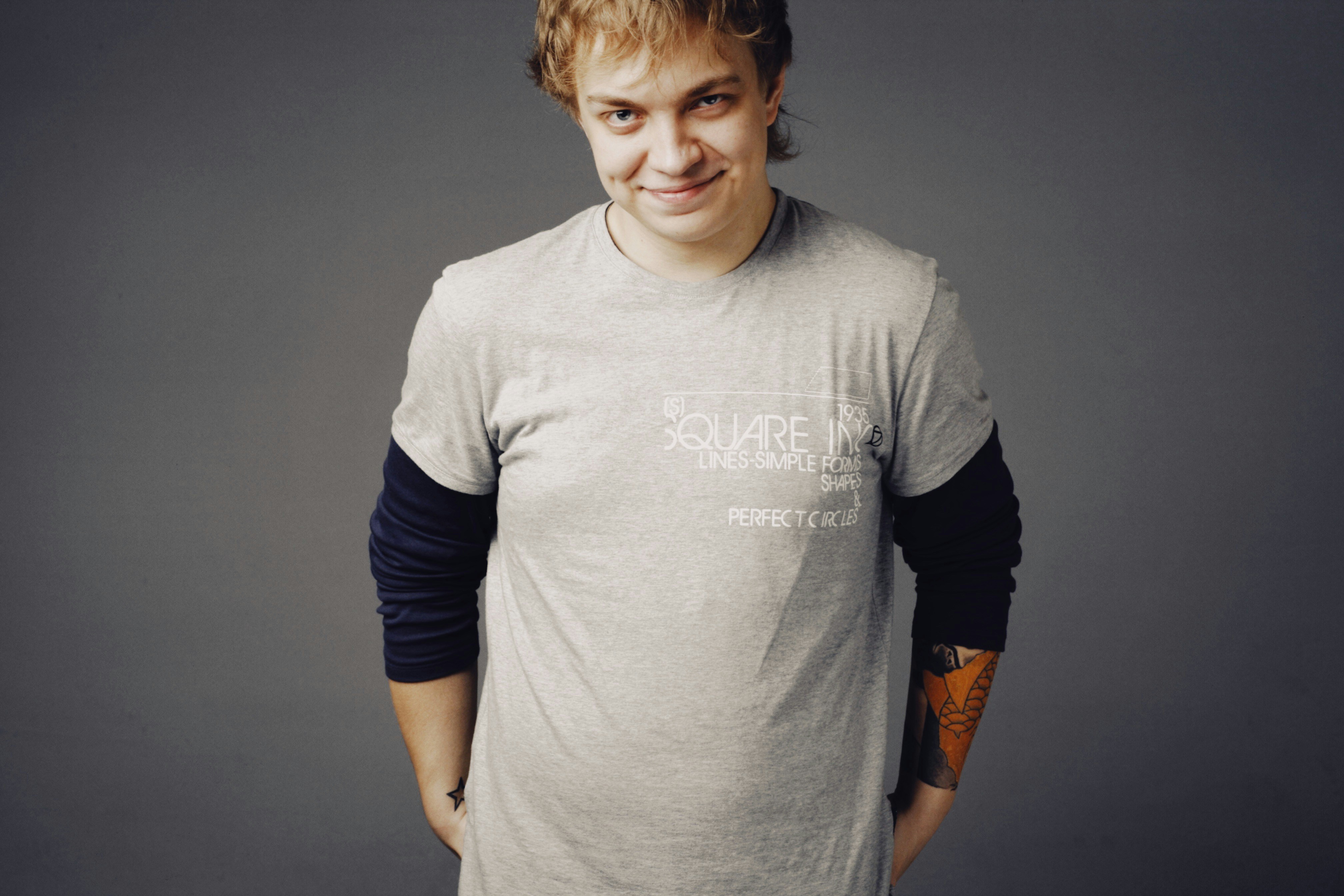 a man with a tattoo on his arm posing for a picture
