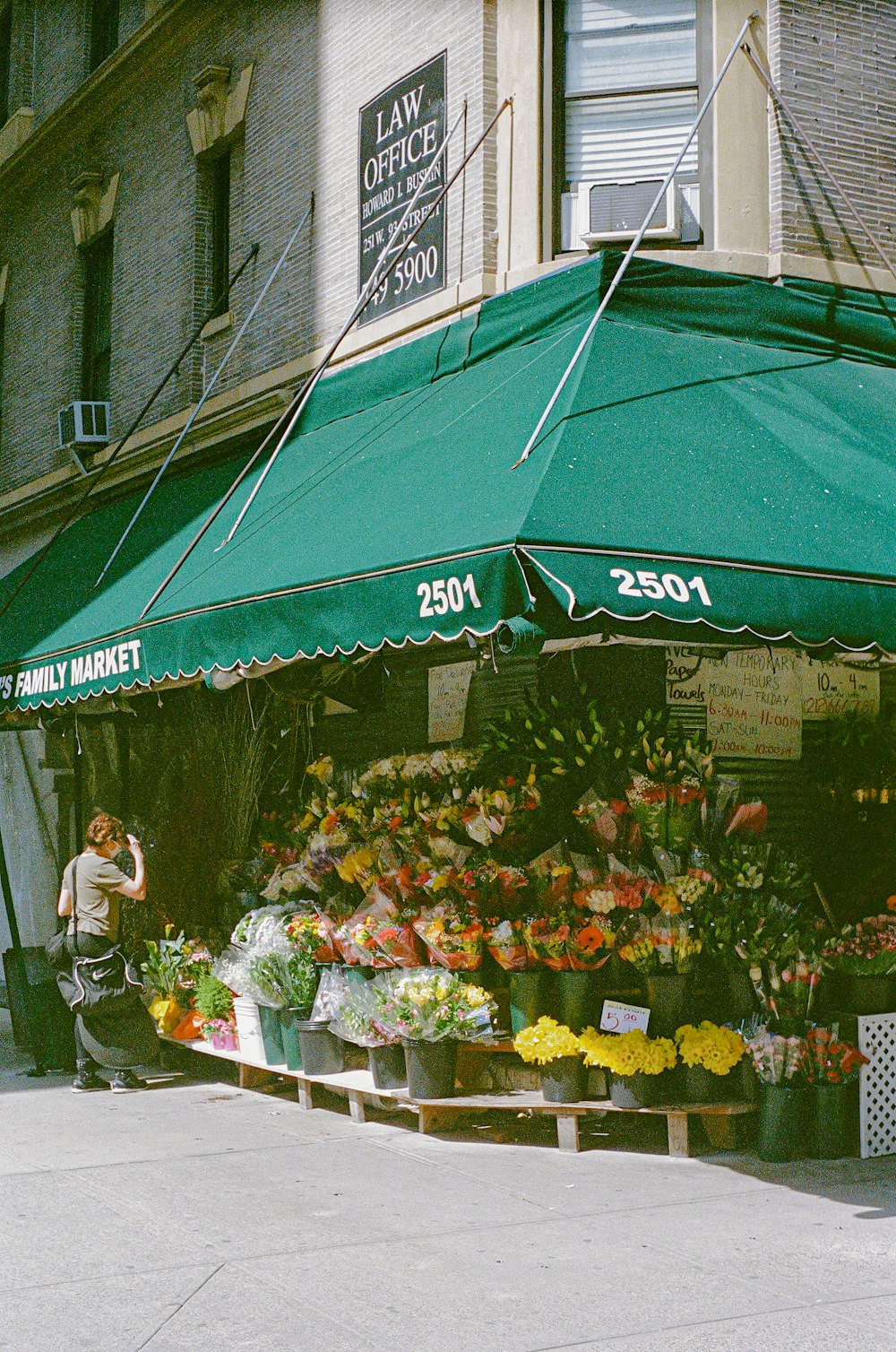 a man standing in front of a flower shop