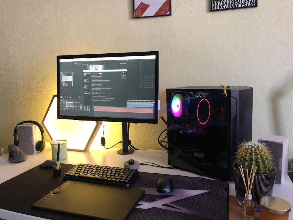 a desk with a monitor, keyboard and mouse