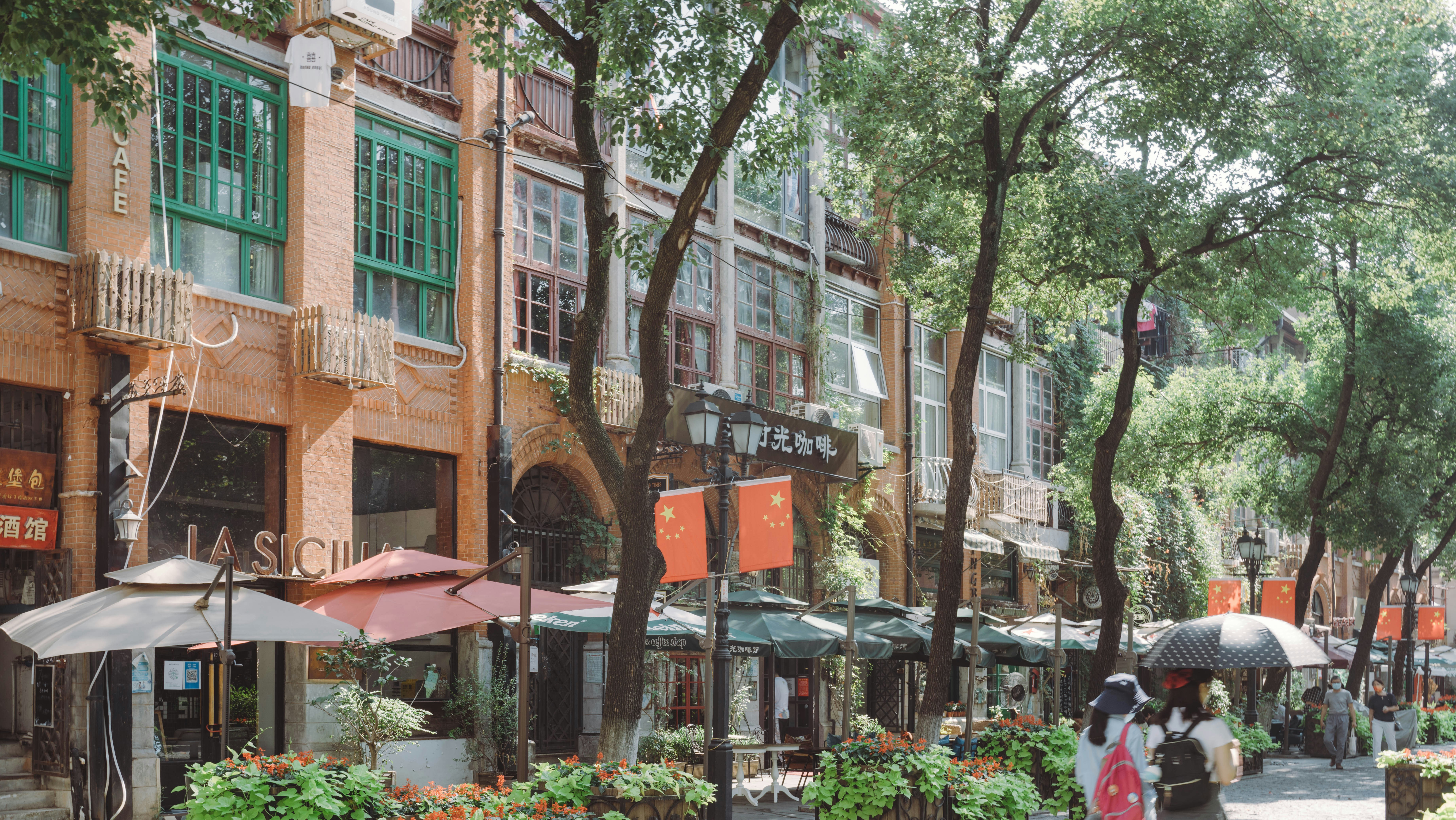 a woman walking down a street holding an umbrella