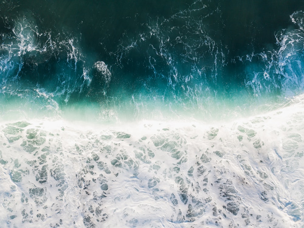 an aerial view of the ocean with waves