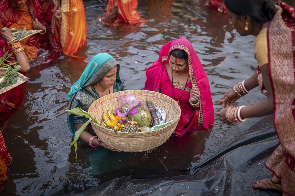 a group of women standing in a flooded area