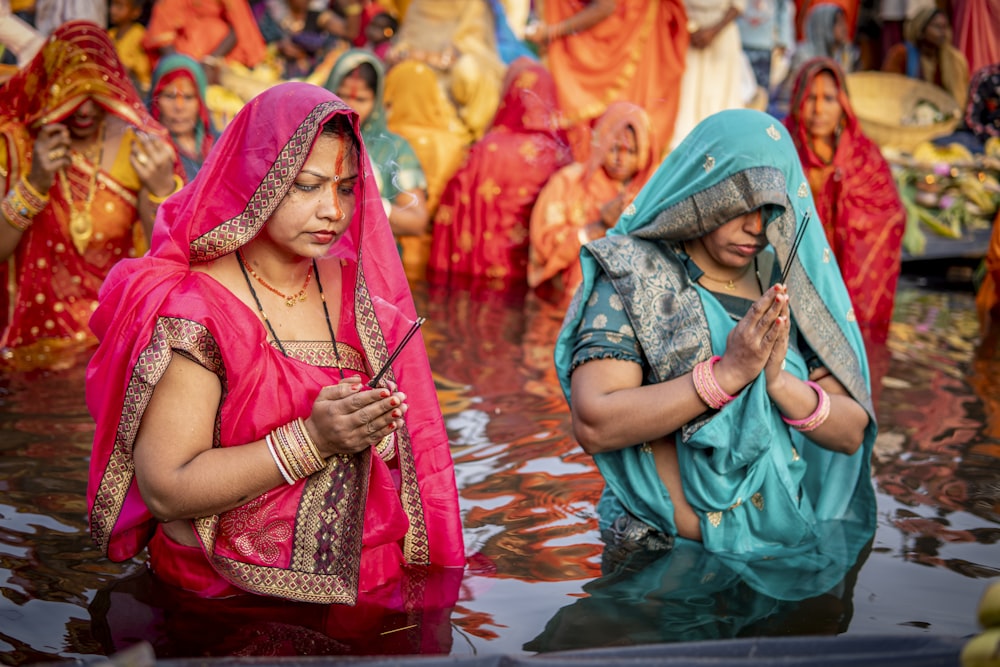 a group of women standing in a body of water