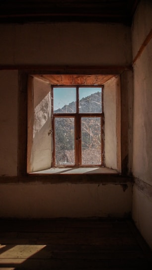 Rustic wooden press extracting fresh mustard oil with sunlight filtering through a kitchen window.