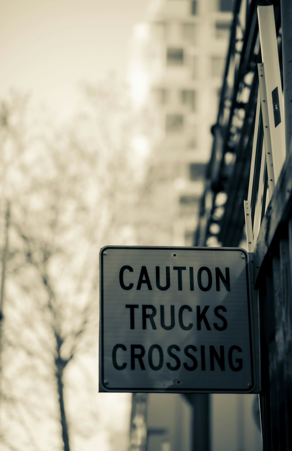 a street sign that says caution trucks crossing