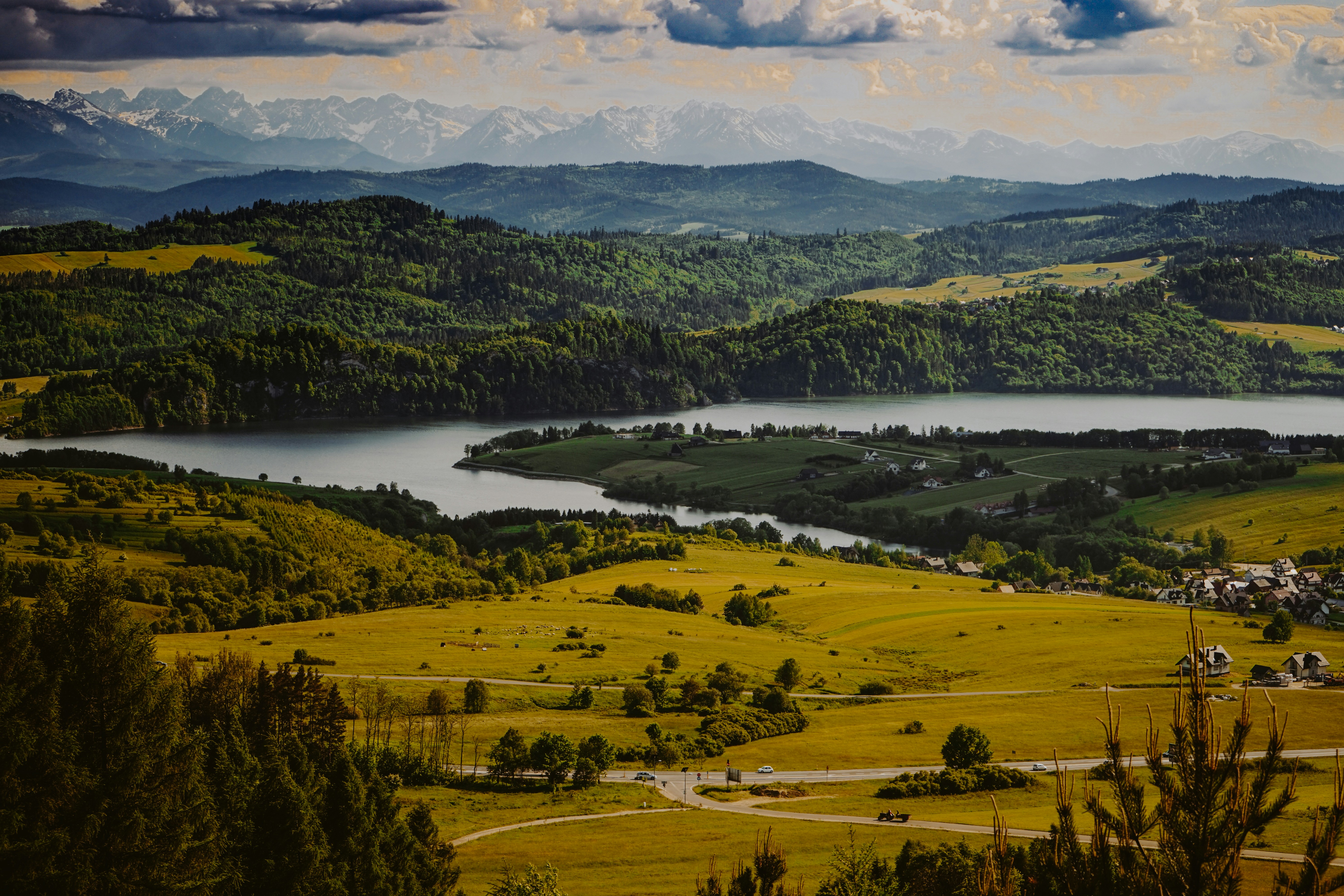 a scenic view of a lake surrounded by mountains