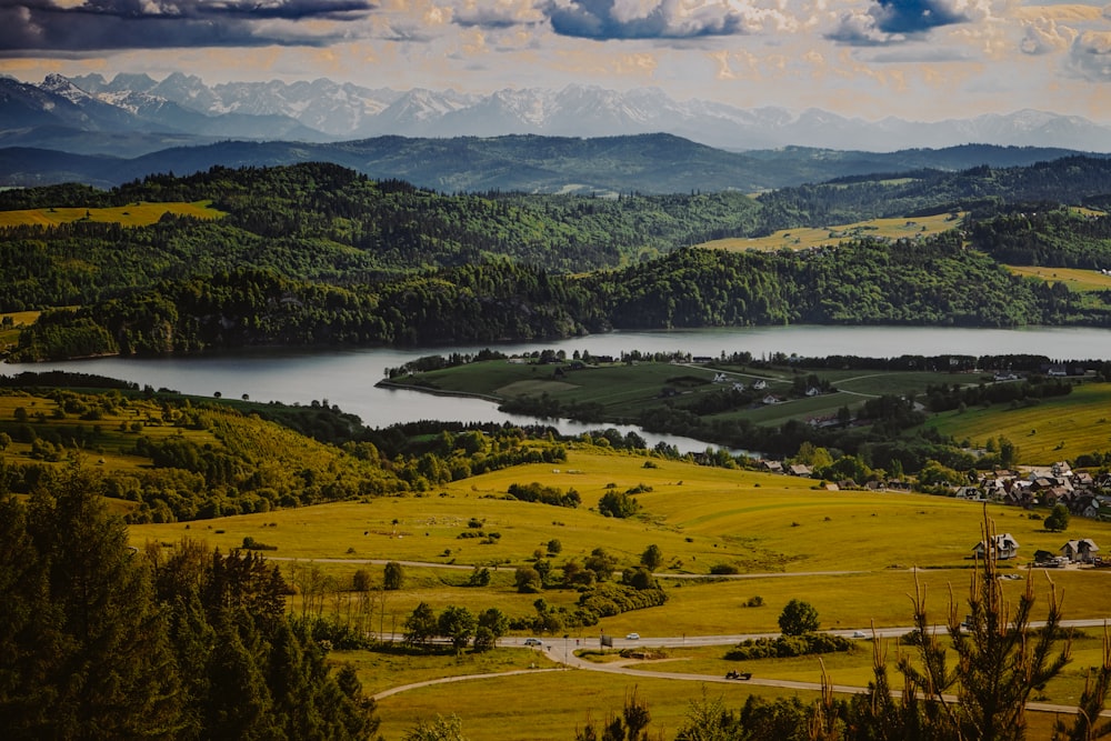 a scenic view of a lake surrounded by mountains