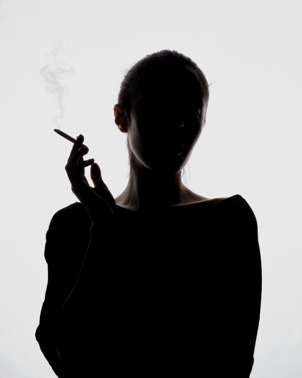 a silhouette of a woman smoking a cigarette