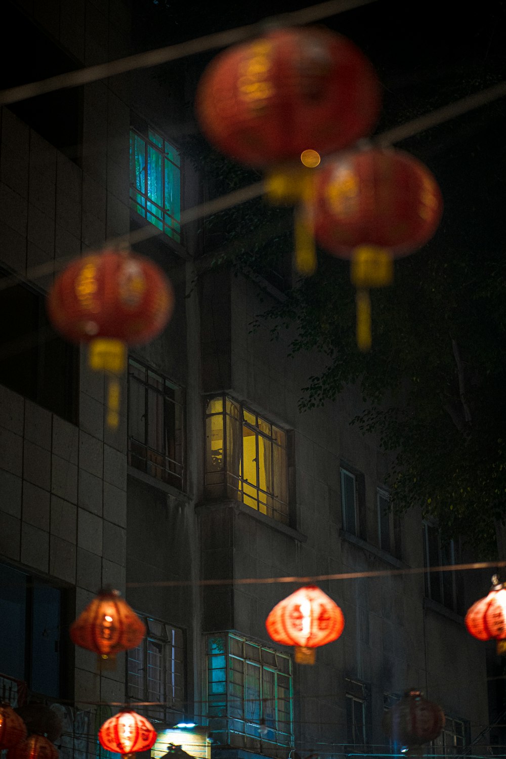 a group of red lanterns hanging from a building