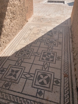 Close-up of a detailed mosaic floor with geometric shapes.