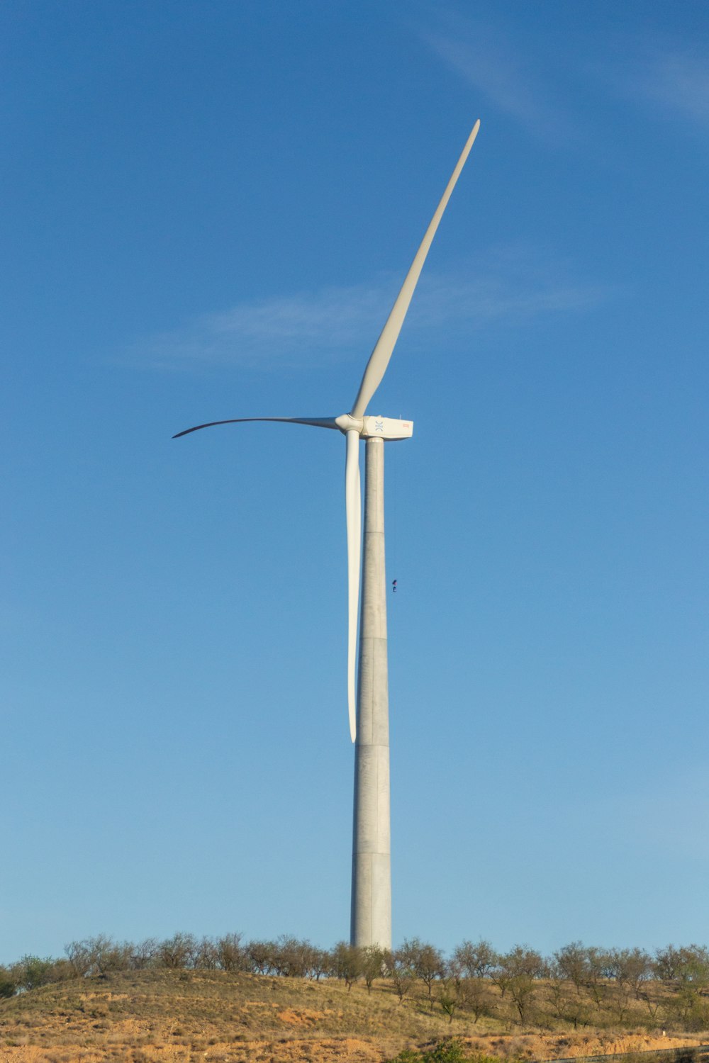 a wind turbine on top of a hill