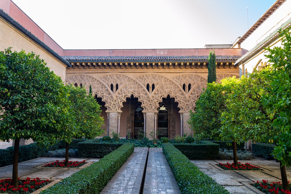 the courtyard of a building with a garden in front of it