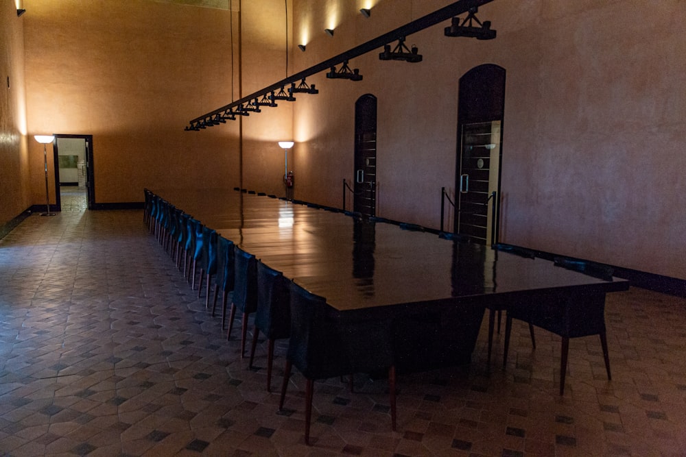 a long table in a large room with many chairs