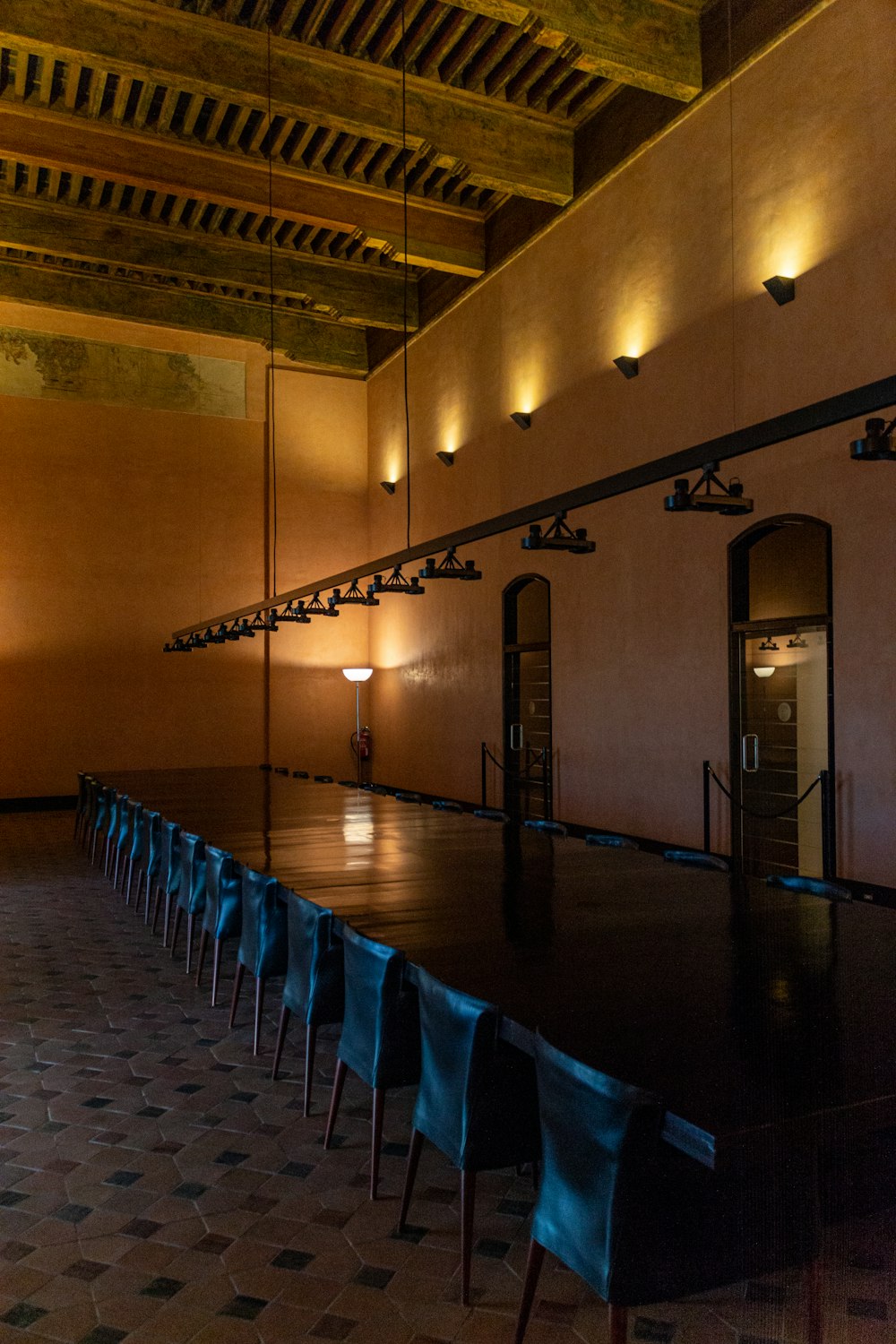 a long table with blue chairs in a room