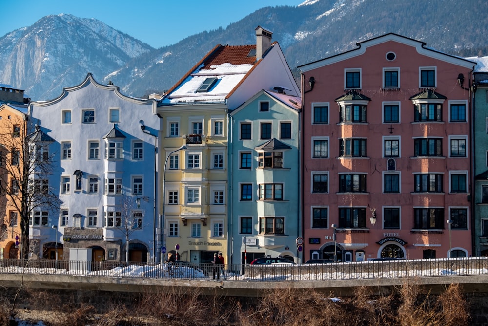 a group of buildings with mountains in the background