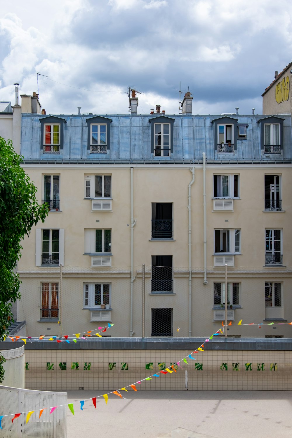 a building with a lot of windows and a lot of flags in front of it