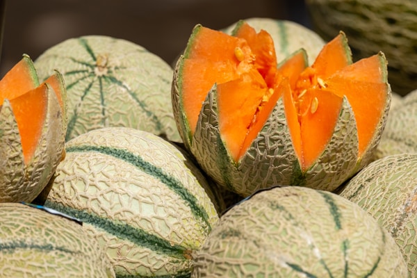 A group of melons with one cut in half
