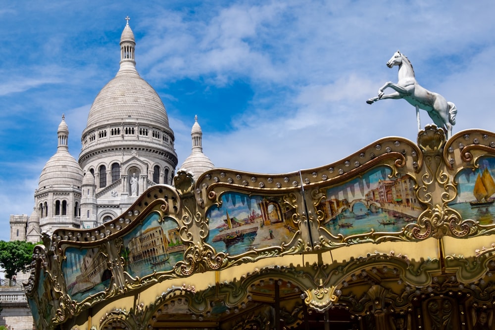 a close up of a merry go round with a building in the background