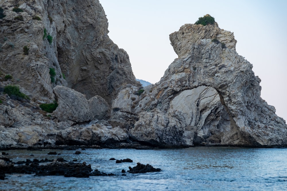 a rock formation in the middle of a body of water