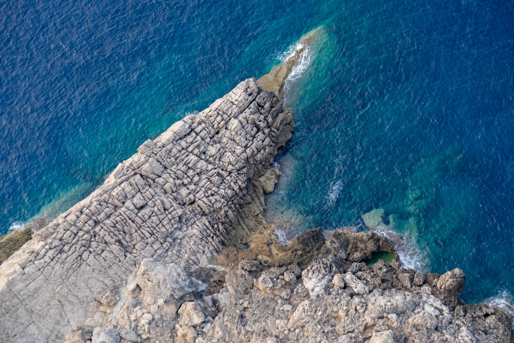 a bird's eye view of the ocean and rocks