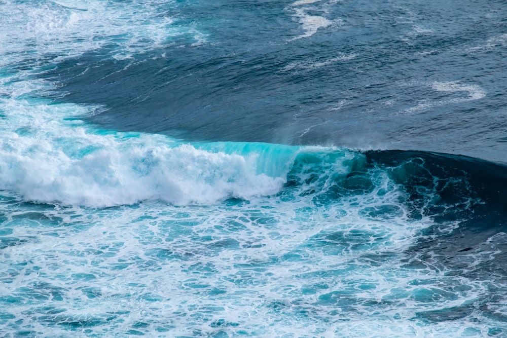 a person riding a wave on top of a surfboard