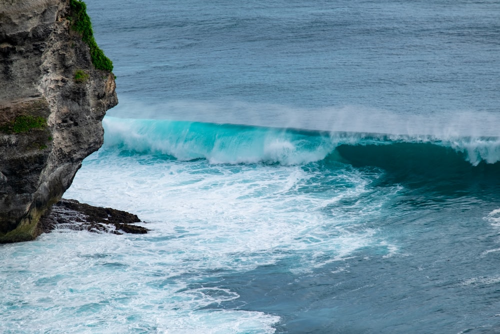 a person riding a surfboard on a wave in the ocean