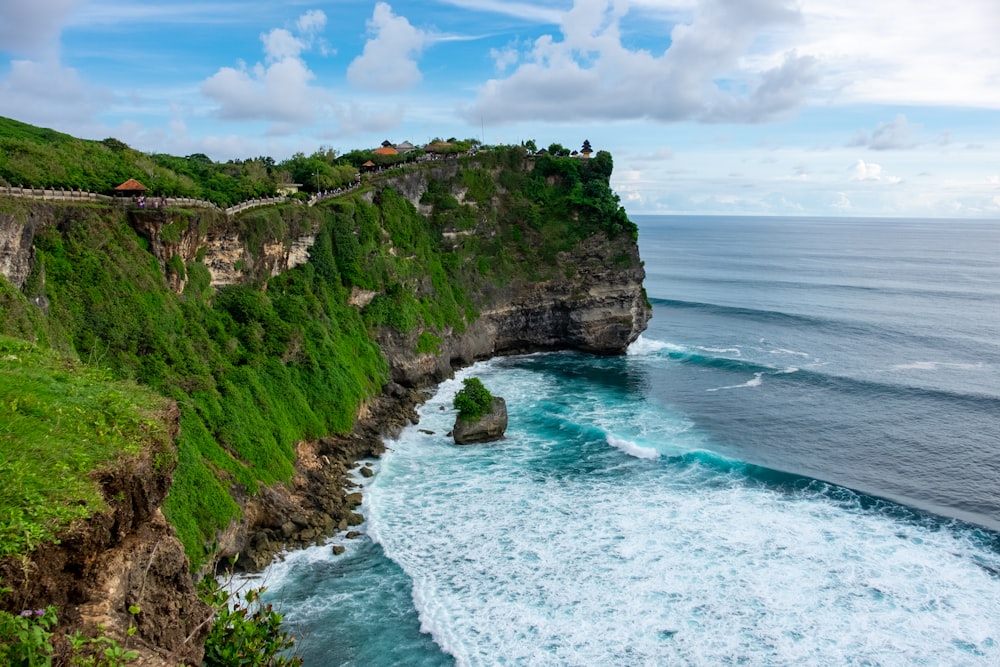 a scenic view of the ocean and a cliff