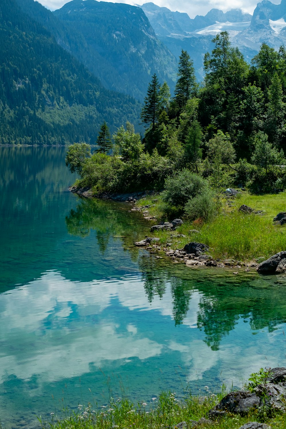 a body of water surrounded by mountains and trees