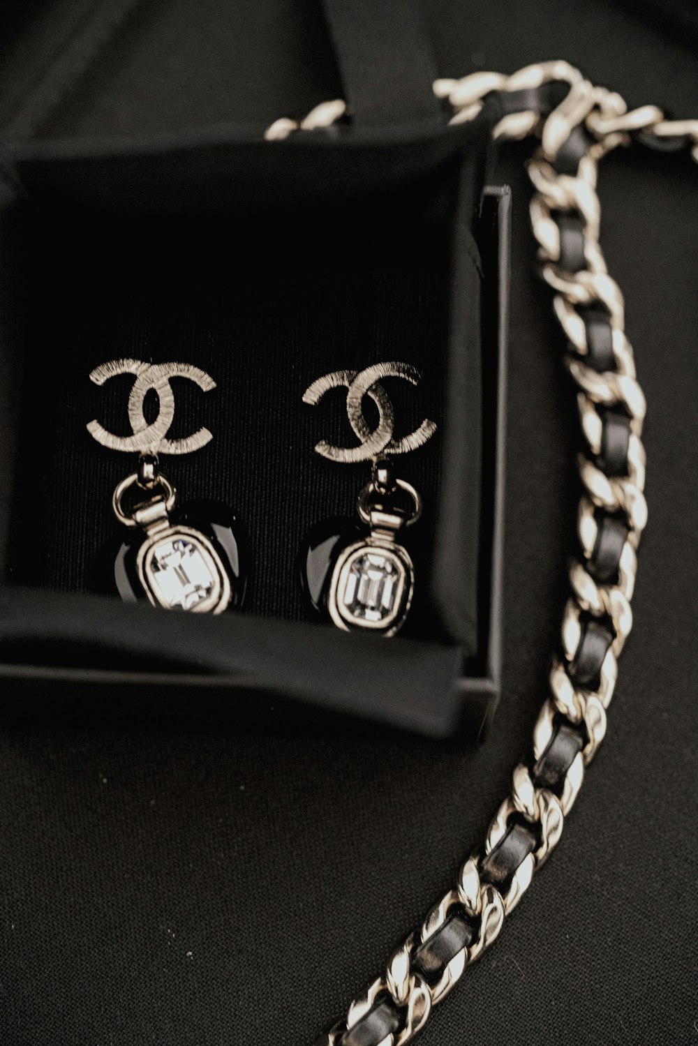 a pair of chanel earrings in a box