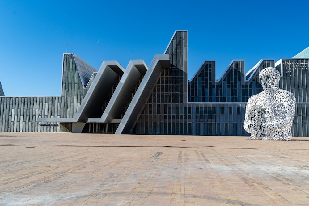 a large building with a statue in front of it