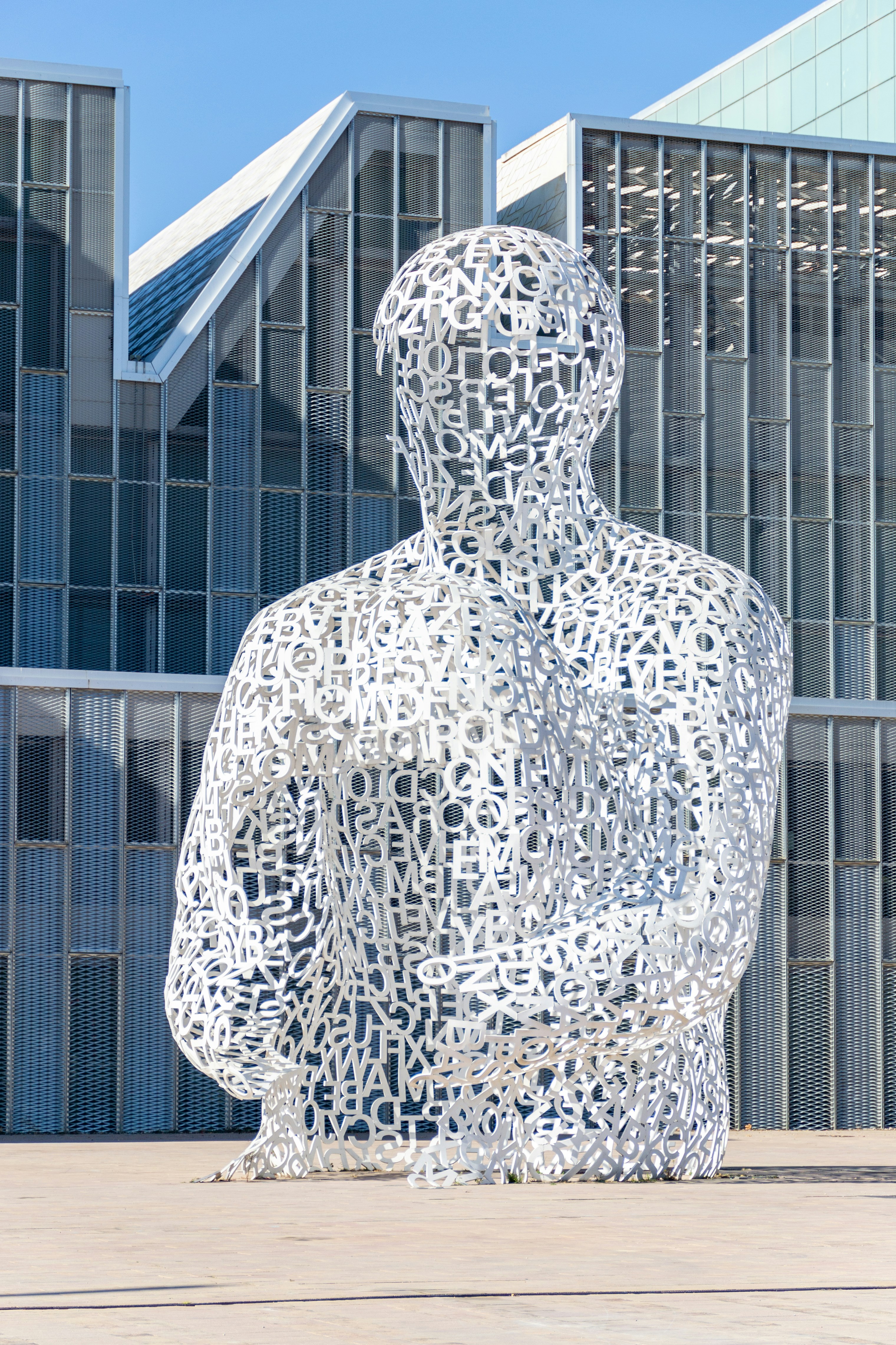 a sculpture of a man in front of a building