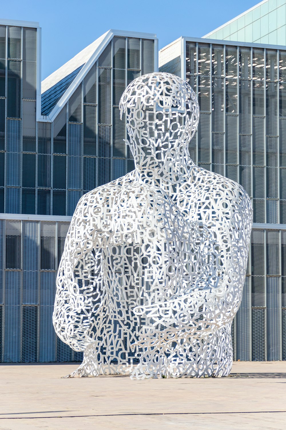 a sculpture of a man in front of a building