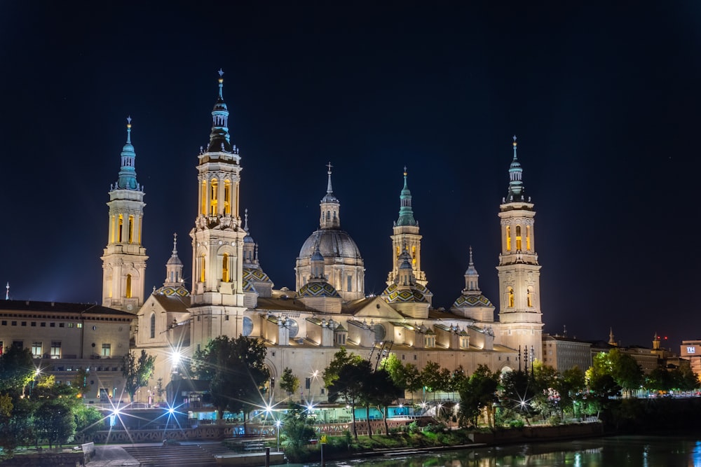 a large cathedral lit up at night in a city