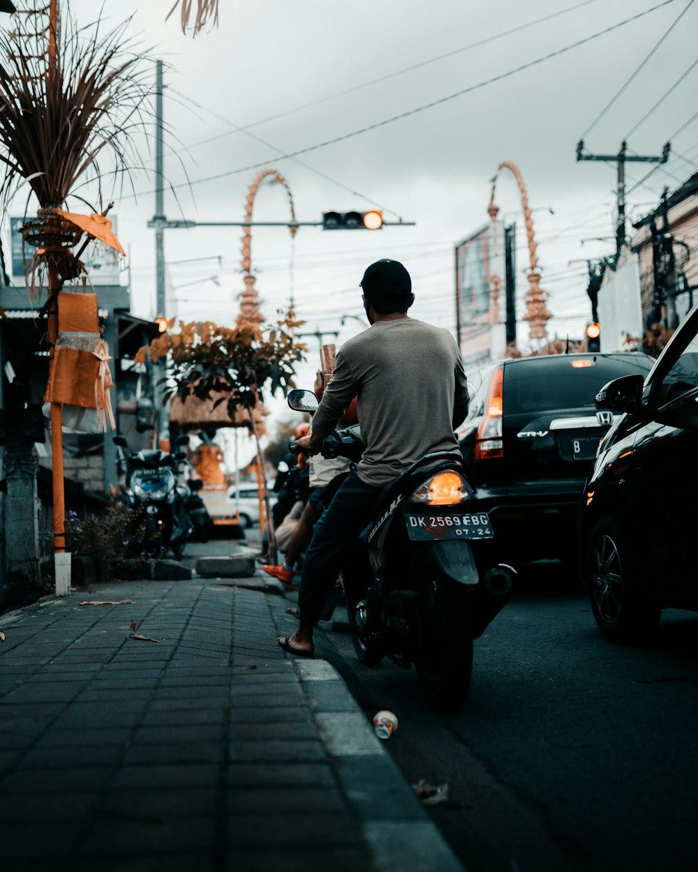 a man riding a motorcycle down a city street