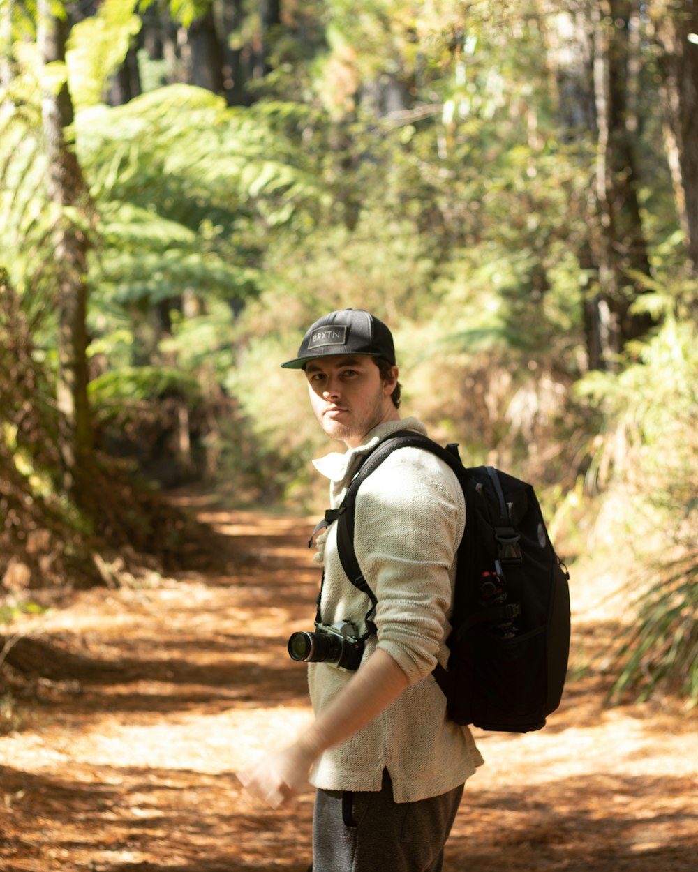 a man with a backpack is walking down a path