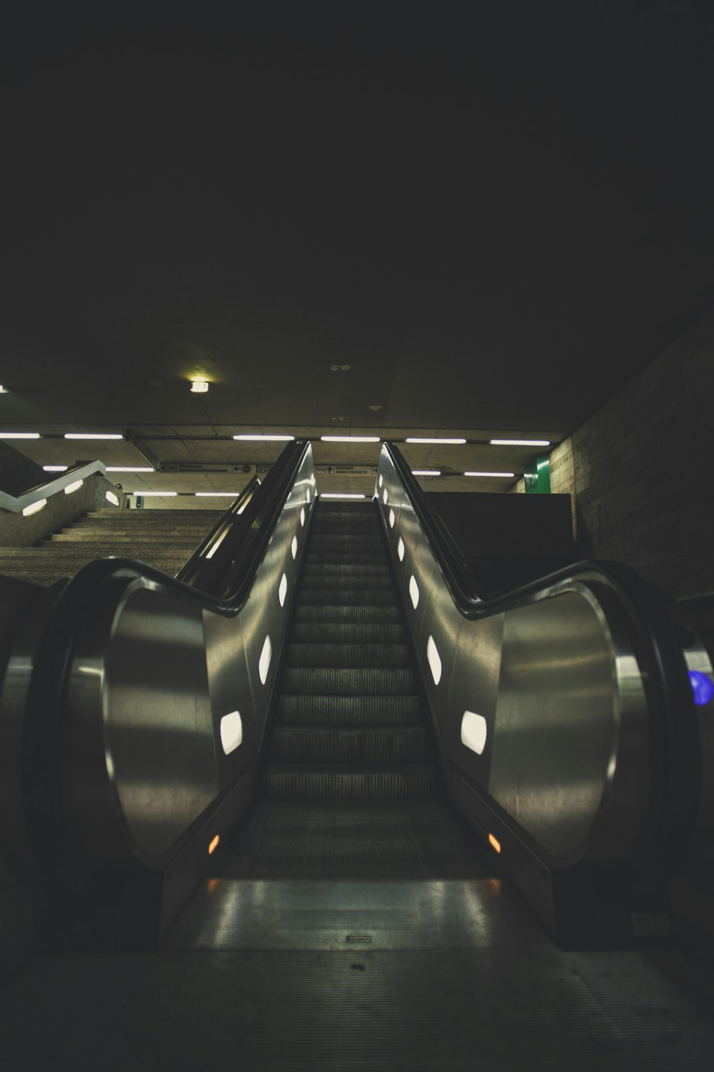 an escalator in a subway station at night