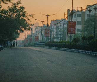 a street with a few people walking down it
