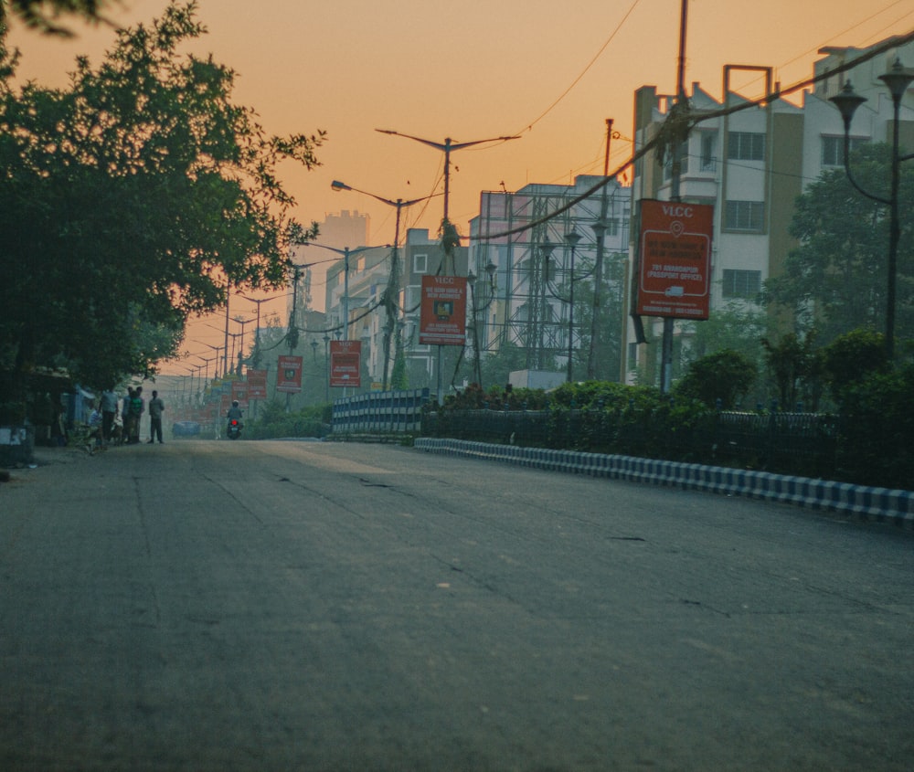 a street with a few people walking down it