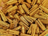 a pile of gold colored objects on a table