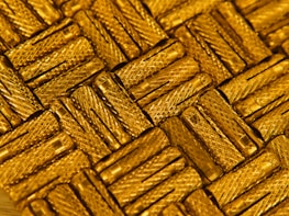 Close-up of shiny metallic gold architectural hardware pieces displayed elegantly.