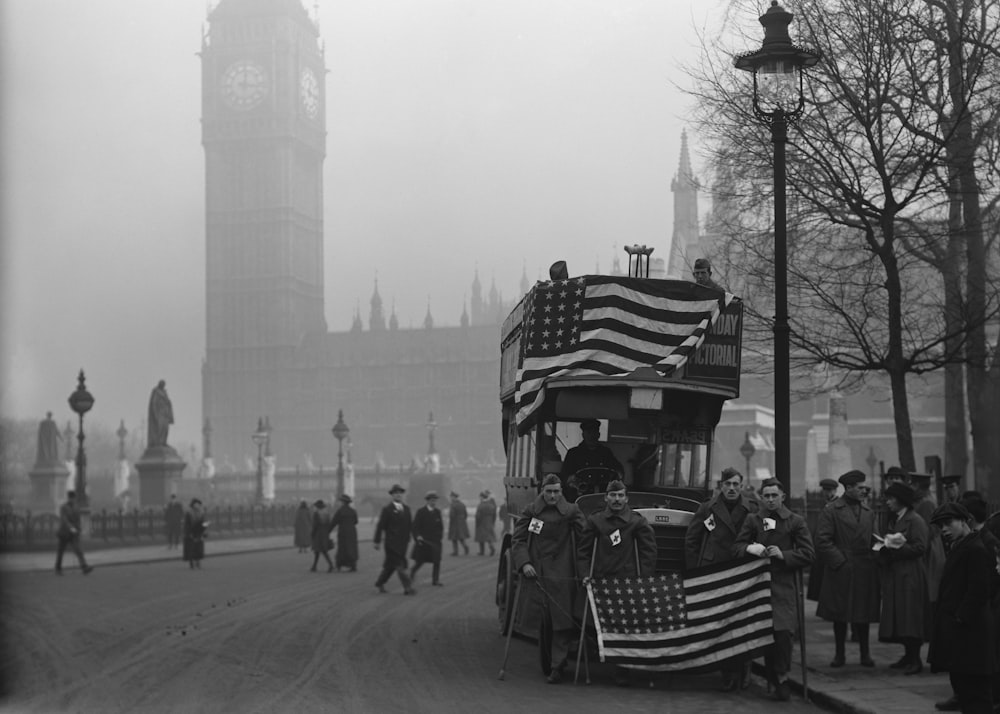 a black and white photo of a bus with an american flag on it