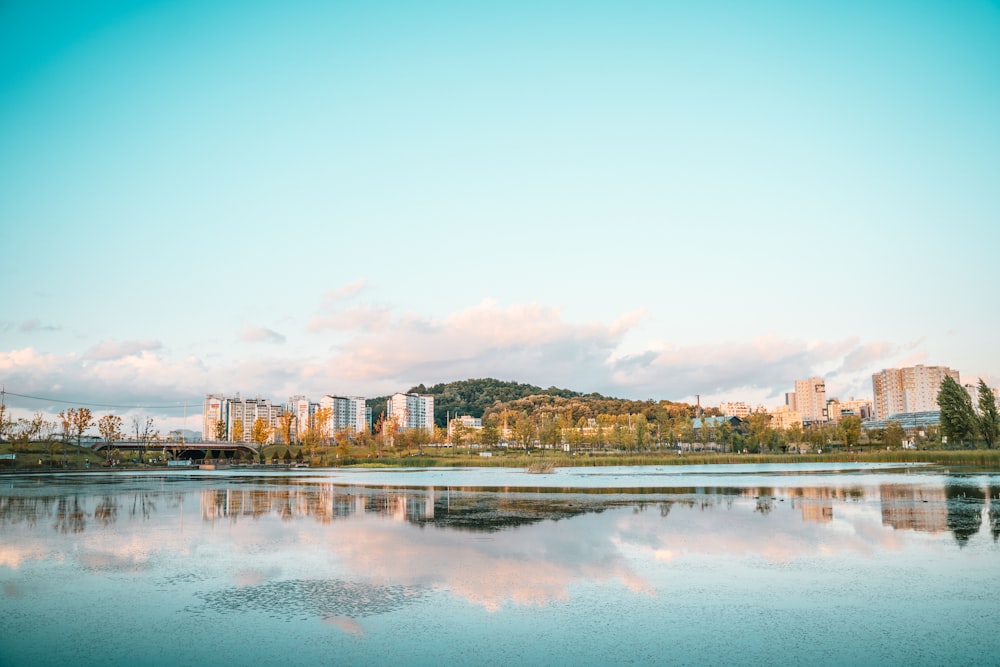 a body of water with buildings in the background