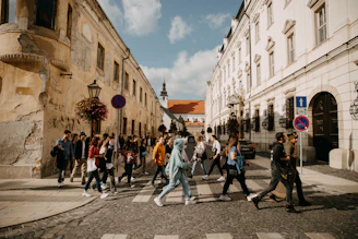 A group of happy travelers exploring a historic European town together.