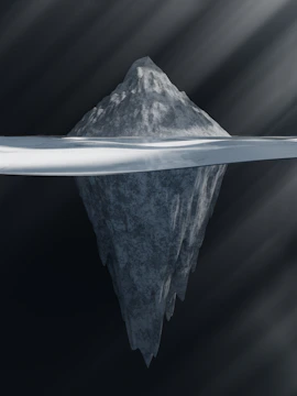 A close-up of an iceberg with a golden pen nib glowing beneath the waterline.