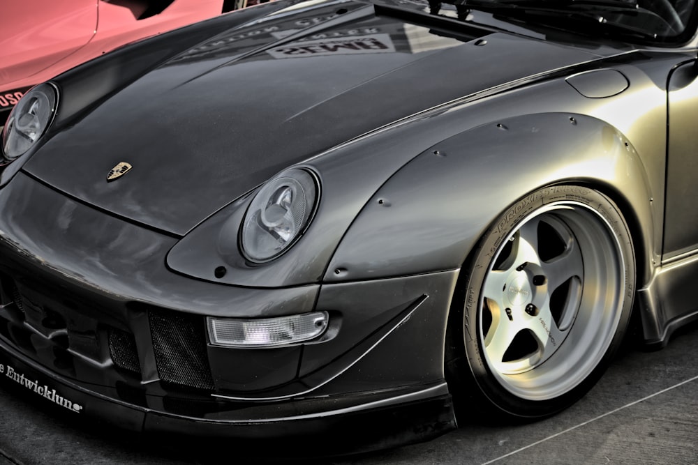 a close up of a sports car parked in a parking lot