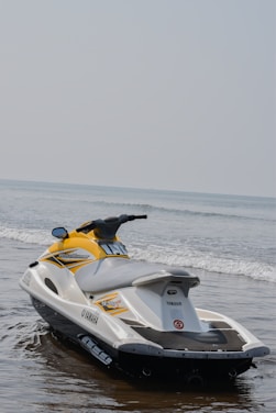 a yellow and white jet ski is in the water