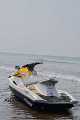 a yellow and white jet ski is in the water