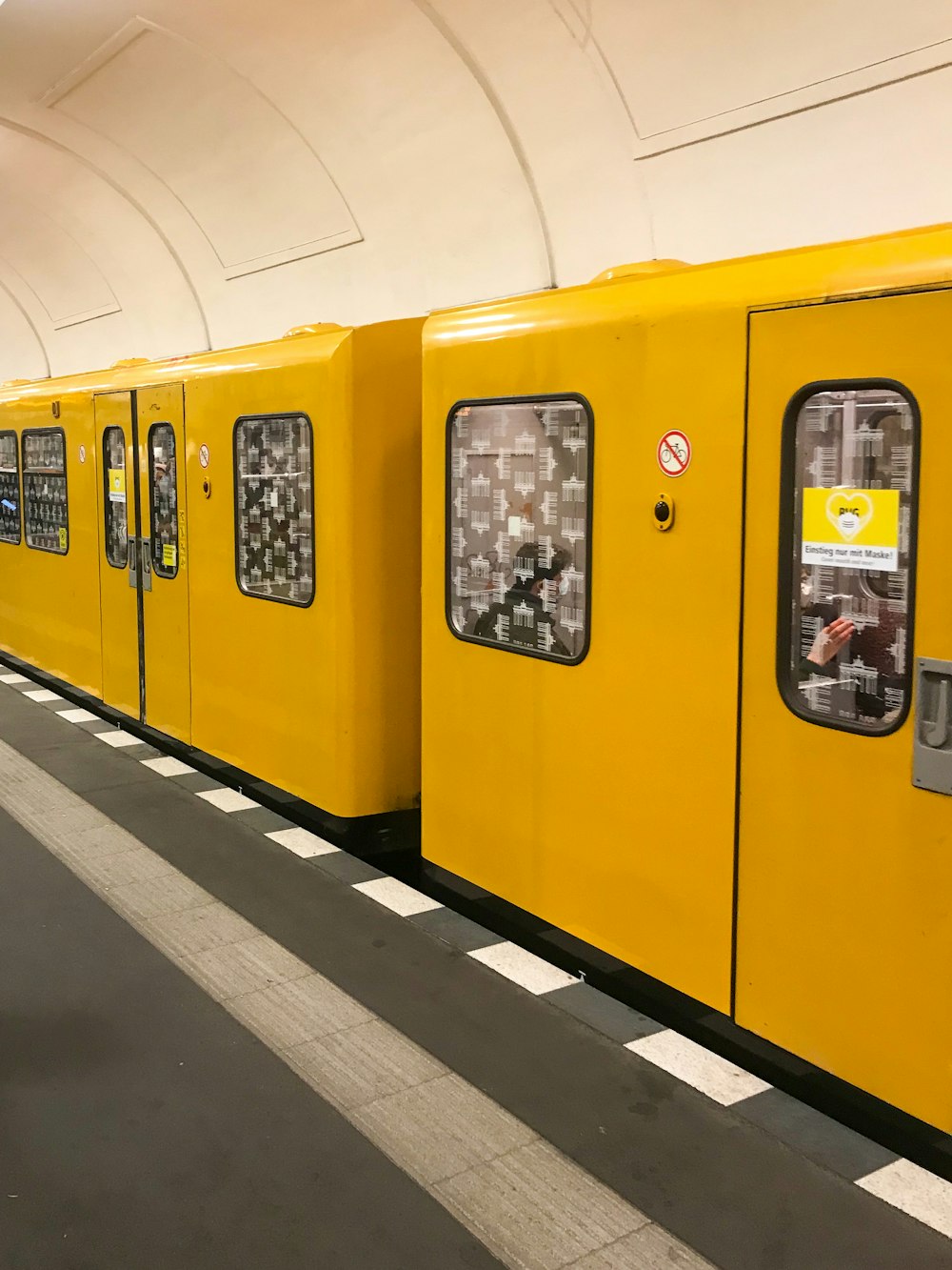 a yellow train stopped at a train station