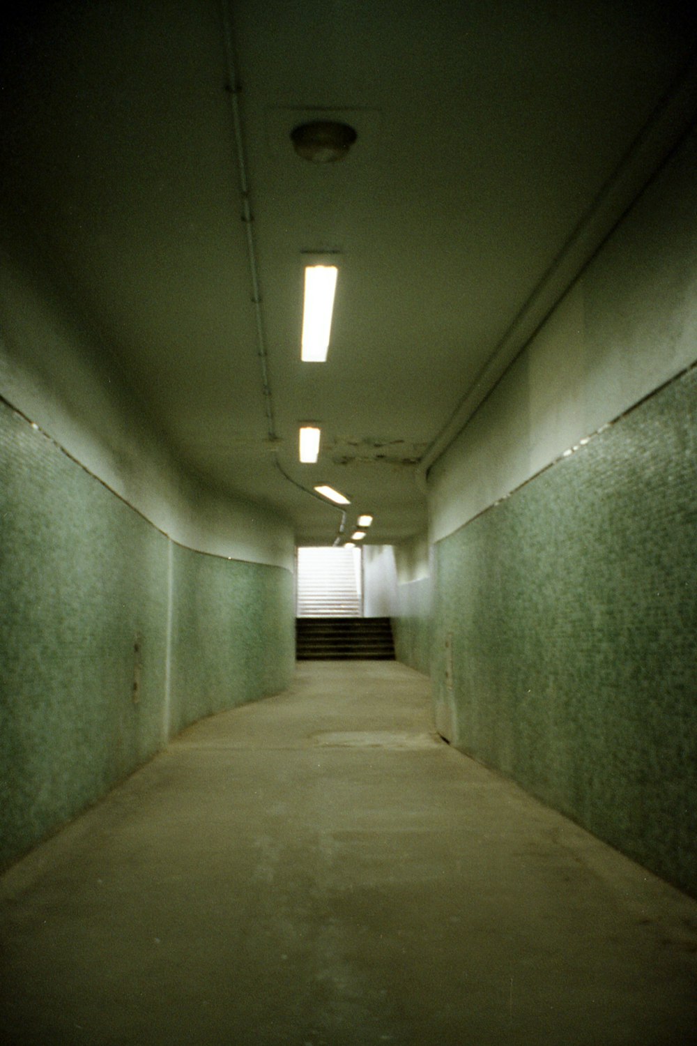 a long hallway with a fire hydrant in the middle of it